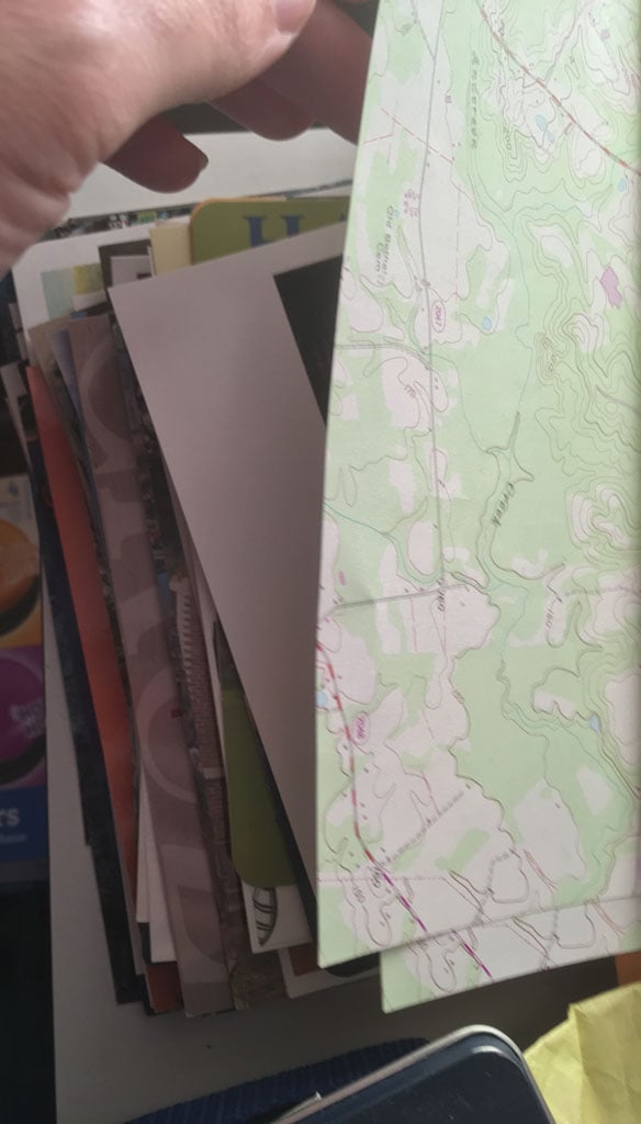 Peeling back the stationery atop the postcards. What's this postcard on the top of the stack?