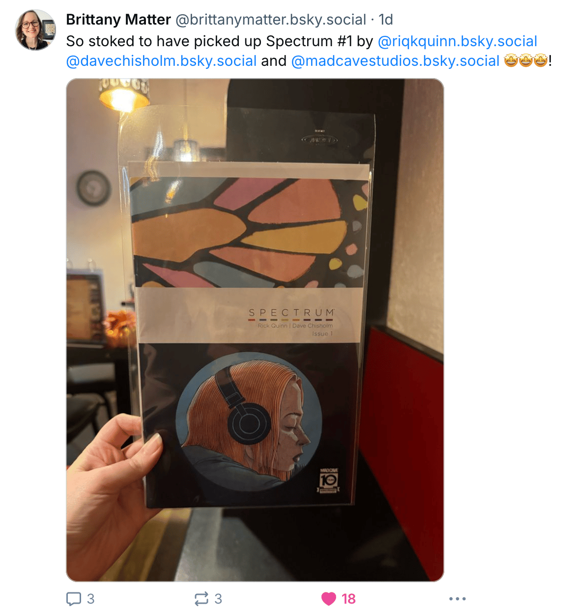 Comic writer and editor Brittany Matter showing off a bag-and-boarded copy of Spectrum #1