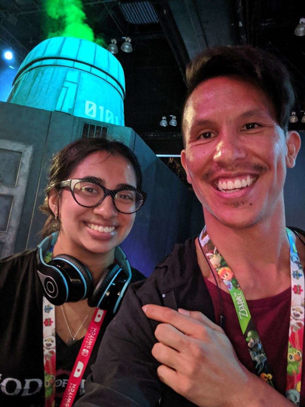 a coworker and i taking a selfie in front of the final fantasy 7 exhibit