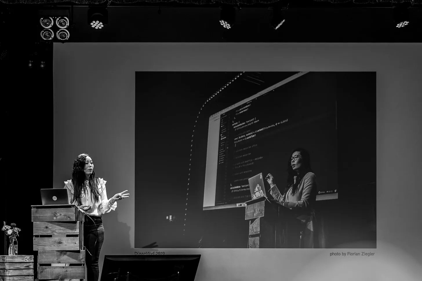 A photo of me on stage in front of a slide with a photo of me on the same stage four years prior. A photo of me on stage in front of a slide with a photo of me on the same stage four years prior.