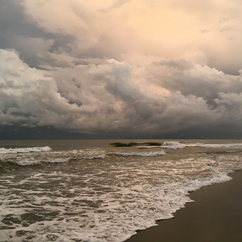the atlantic ocean with stormy clouds overhead