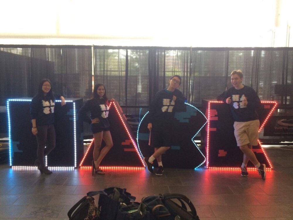 standing in front of the hackMIT sign