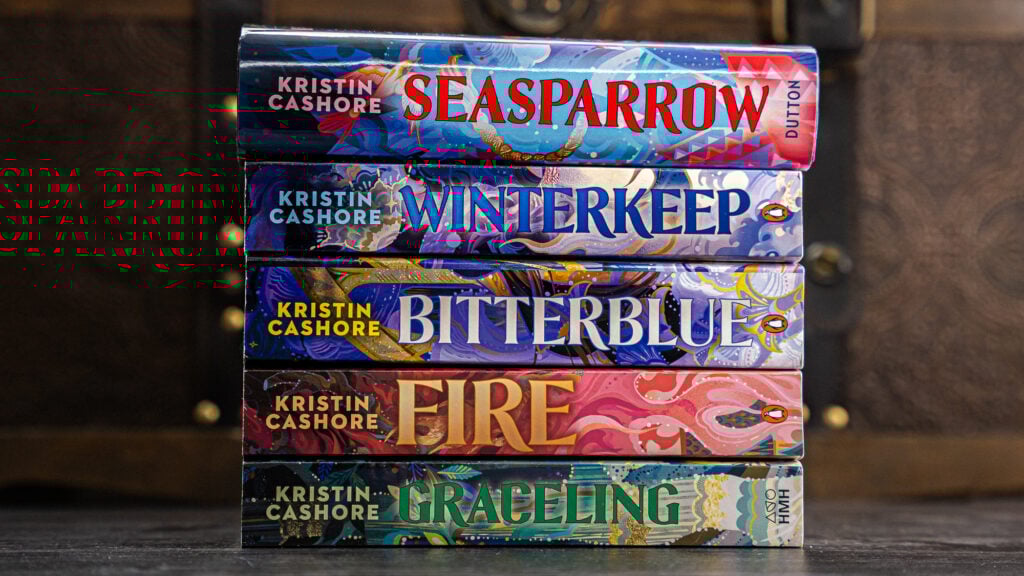 the five graceling realm books in a pile--graceling, fire, bitterblue, winterkeep, and seasparrow