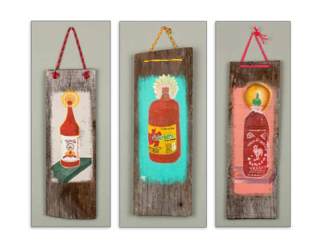 three kitchen saints hanging together a tapatio bottle, a valentina and a sriracha 