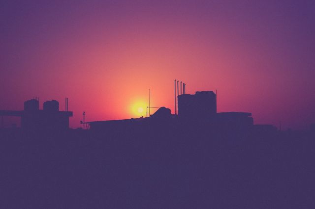 Sunrise over a city rooftop. Source: Unsplash