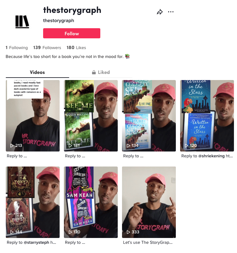 Screenshot of our new TikTok page. At the top of the page is our handle 'thestorygraph'. The "Videos" tab is selected and you can see 7 video preview shots, all feature Rob's face. He is wearing a black t-shirt with the words "Mr. StoryGraph" on it in pink letters and a pink baseball cap. Some of the video previews feature Rob holding up an iPad to the camera with a book cover displayed on it. Above the iPad is an image of the book cover, overlayed.