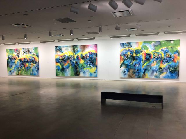 exhibition view of Leslie Martinez paintings, three large colorful canvases adorn a white wall