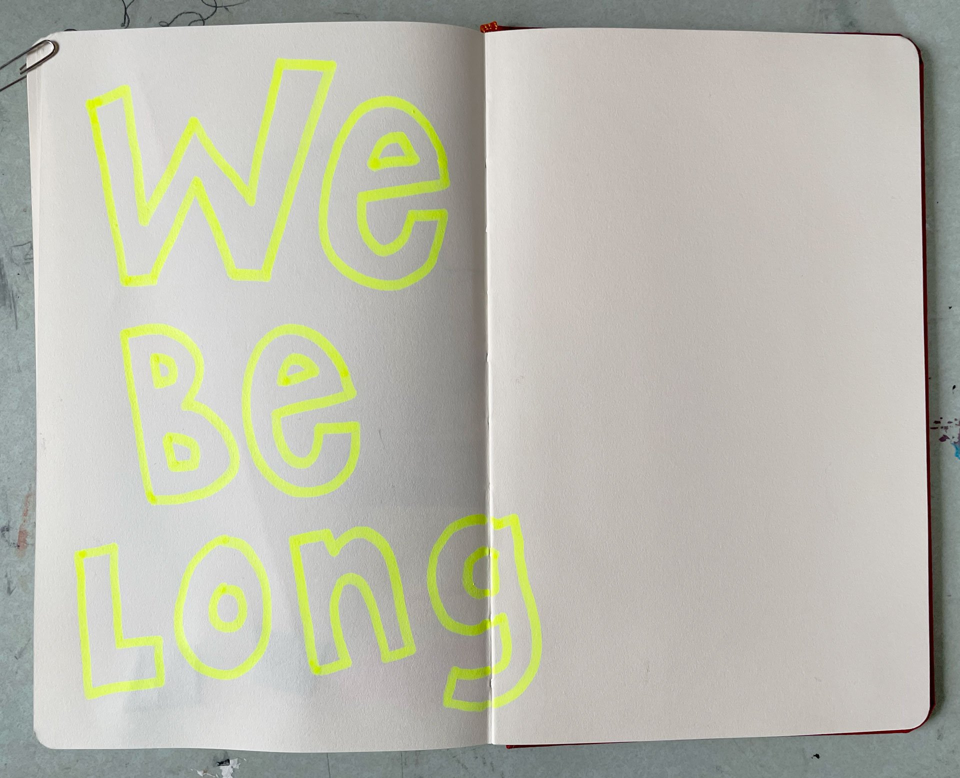 Written words "we belong"