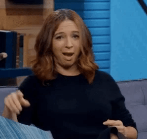 Animated image of actress Maya Rudolph blowing kisses and making a heart shape with her hands.