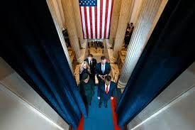 members of the criminal Trump Family on the escalator in Trump Tower