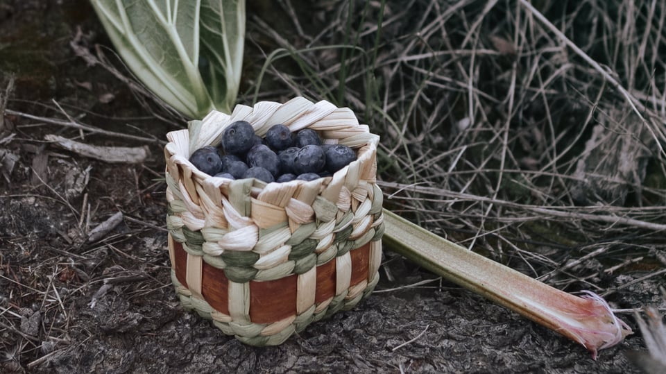 A small berry basket woven from cattail