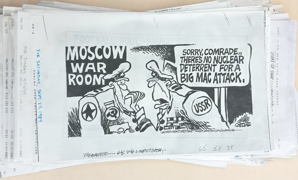 Pile of faxes of Mike Peters’s United Features editorial cartoons, 1980s