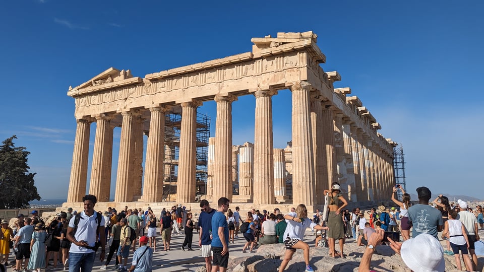 The Parthenon, located on the Acropolis, against a clear azure sky.