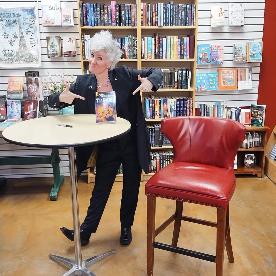 Me standing in a bookstore pointing to a copy of The Get Off