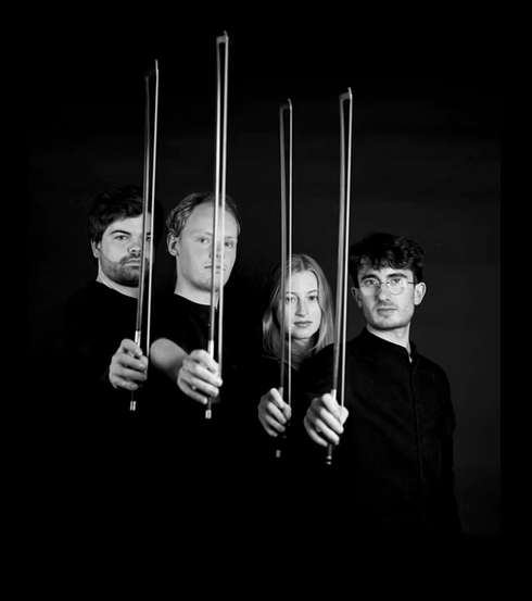 A high contrast photo of performers against a dark background holding bows.