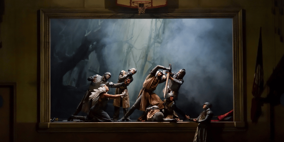 A group of dancers in a theatre dressed as knights.