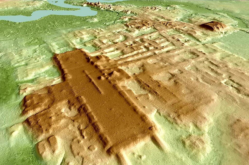 An aerial, topographic view of brown mounds standing out from green landscape, centered on an enormous rectangle.