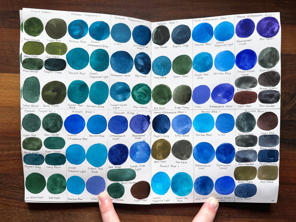 A spread of mostly blue watercolor swatches.