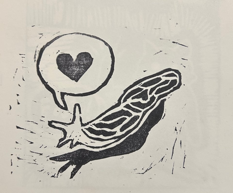 A crude linocut print in black ink on white paper, showing a leopard slug. It has a speech bubble with a heart.