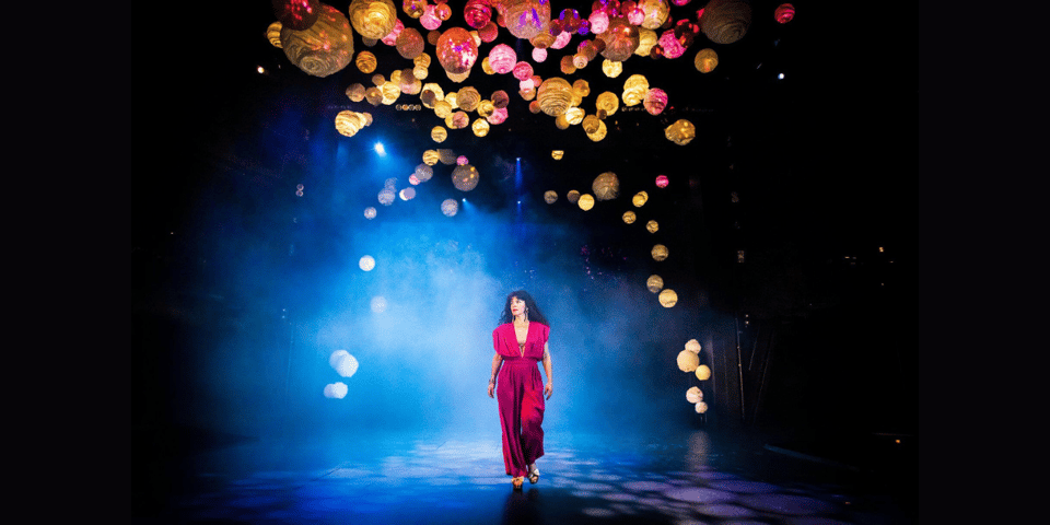 Titania makes her entrance under a cloud of lanterns.