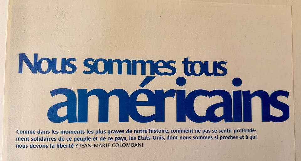 A text-based image presenting a quote by Jean-Marie Colombani, with the phrase "Nous sommes tous américains" in large blue letters. Smaller text reads "Comme dans les moments les plus graves de notre histoire, comment ne pas se sentir profondément solidaires de ce peuple et de ce pays, les Etats-Unis, dont nous sommes si proches et à qui nous devons la liberté ?"