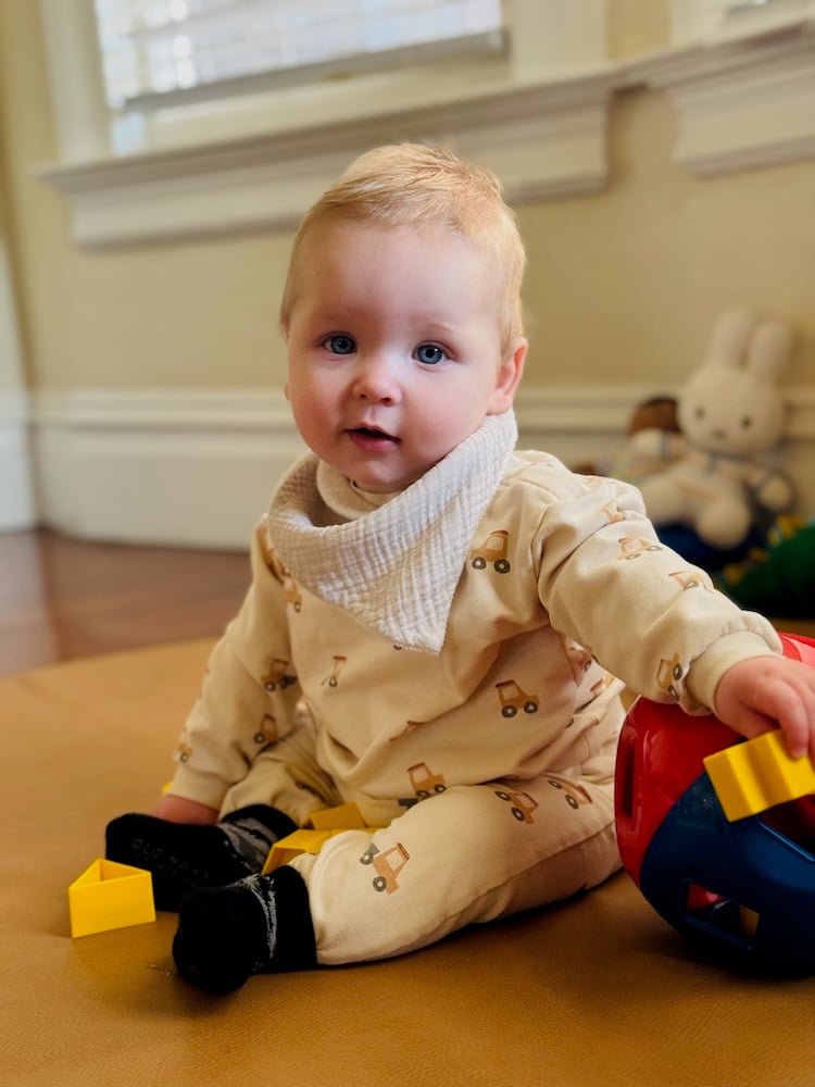 A portrait of Rory sitting on his play mat