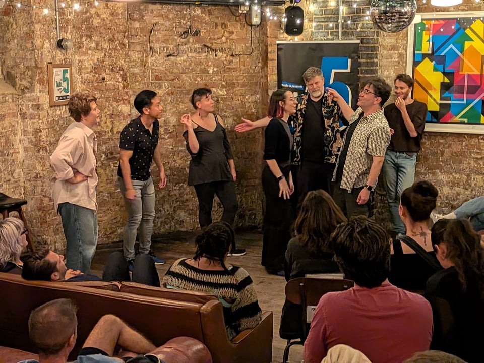 the cast of The Pretend Company + Roy and Kaci, on stage at Table 5 Improv's show.