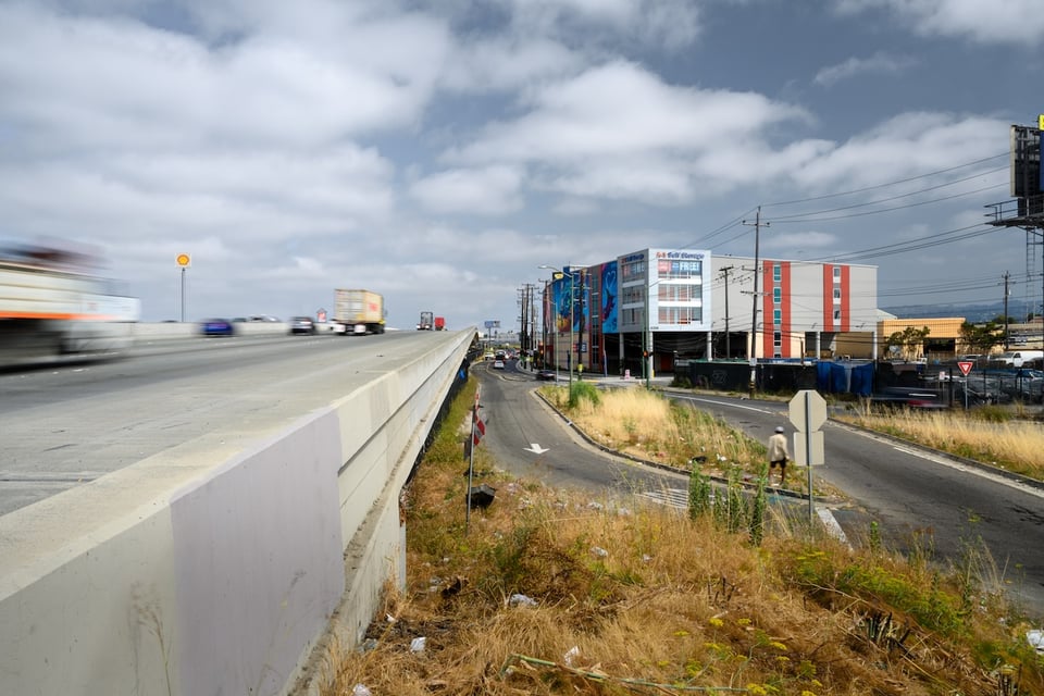 A perspective view of a freeway and a self-storage warehouse.