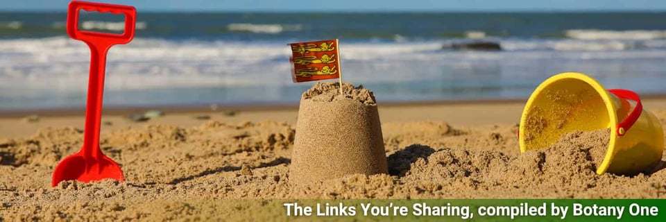 A photo of a bucket and spade and a sandcastle.