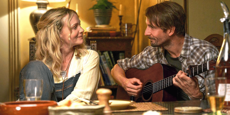A folk duo singing at the table.