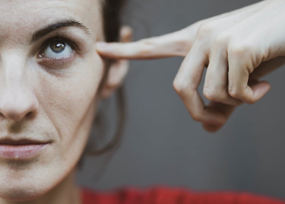 a woman touching her ear