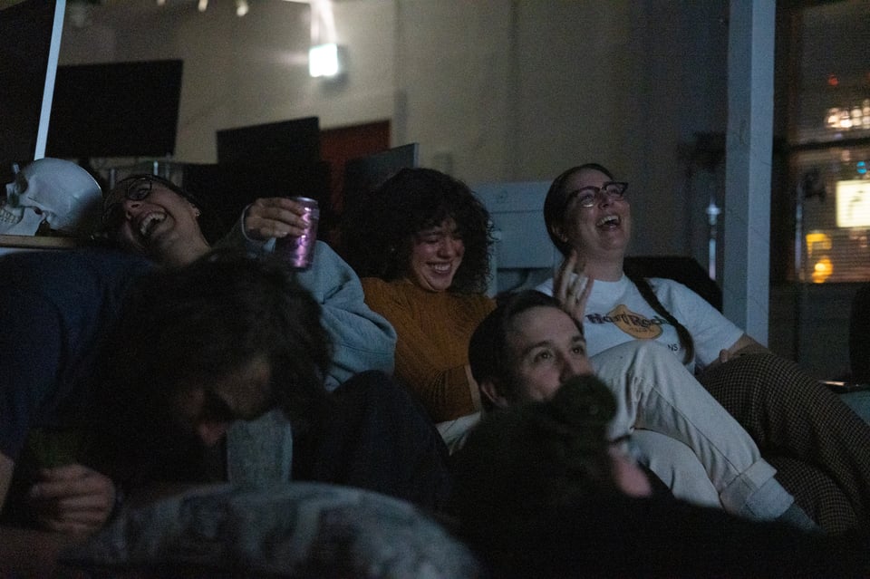 People laughing at a TV show.