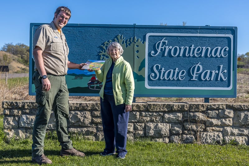 Kathy Ause presented Frontenac State Park manager Jake Gaster with a copy of her new book, “The Blufftop Adventures of Minnie the Goat.” Jake’s three little ones, who keep him even busier than us Frontenac State Park Association gadflies, are sure to enjoy it! / Photo by Karla Jeselson