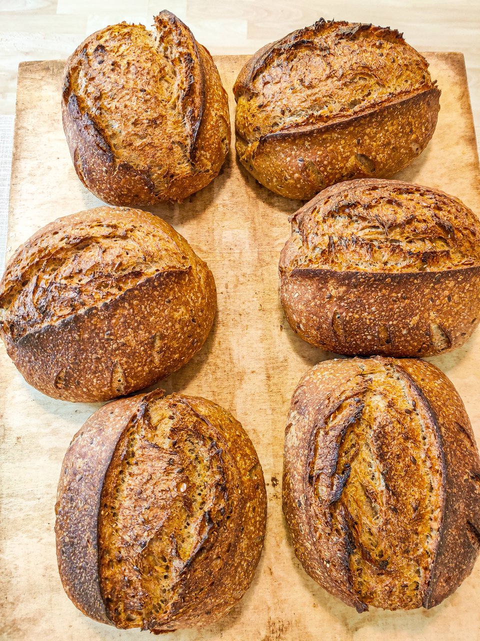 six loaves of bread on a cutting board