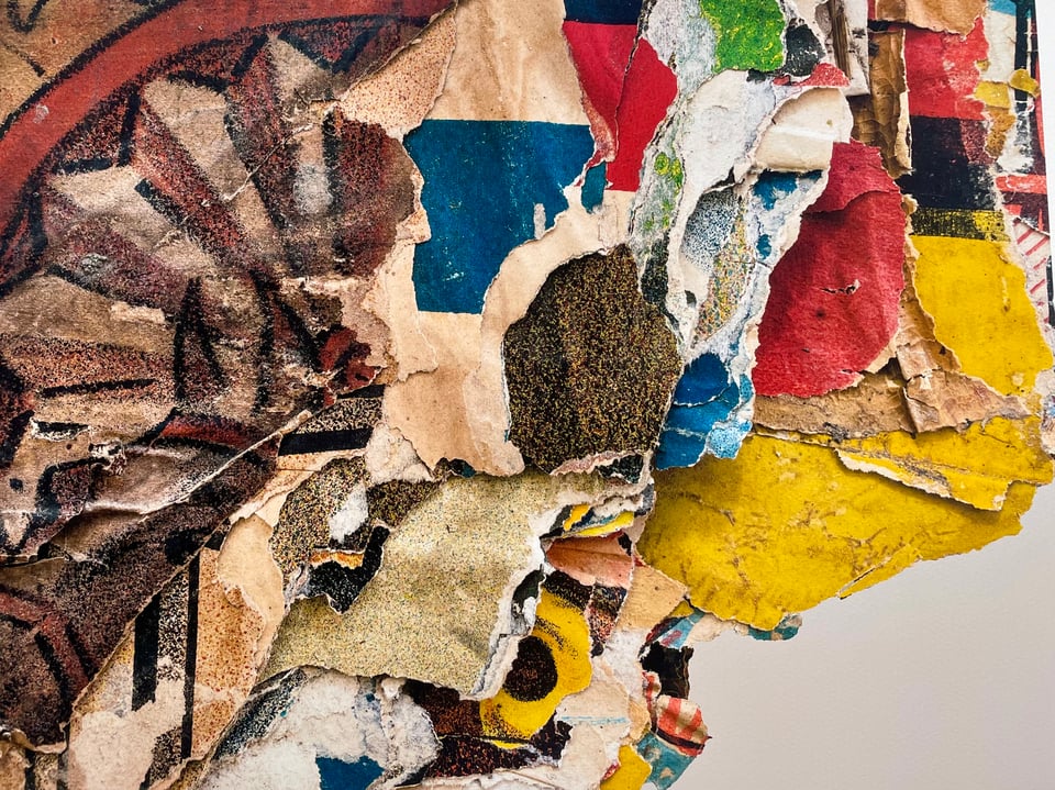 Many layers of prints pasted on top of one another, lots of colors and jagged edges. Looks like abstract art