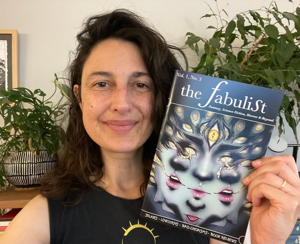the author T. K. Rex grinning like a doofus with a copy of The Fabulist. The cover of vol. 1, no. 3 has a trippy psychedelic illustration of a face with too many eyes. Houseplants in the background. Is that a LucasArts teeshirt!? Hard to tell with the way it's cropped, but it might be.