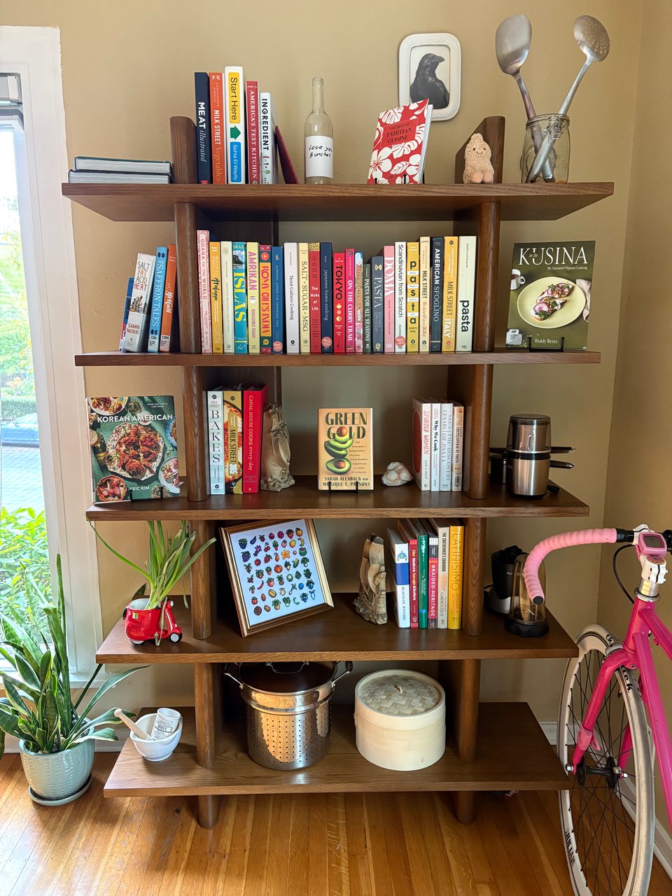 The author's bookcase, containing a couple dozen books and other kitchen gear.