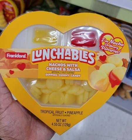 Heart-shaped box of Lunchables brand gummy candy labeled nachos and cheese but it is actually pineapple-flavored