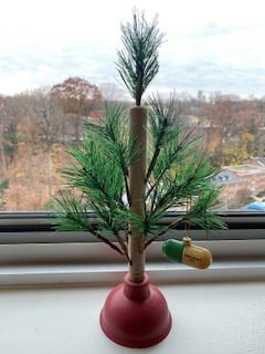 a 15-inch "christmas tree" that is a plunger with fake branches, decorated with a Prozac ornament