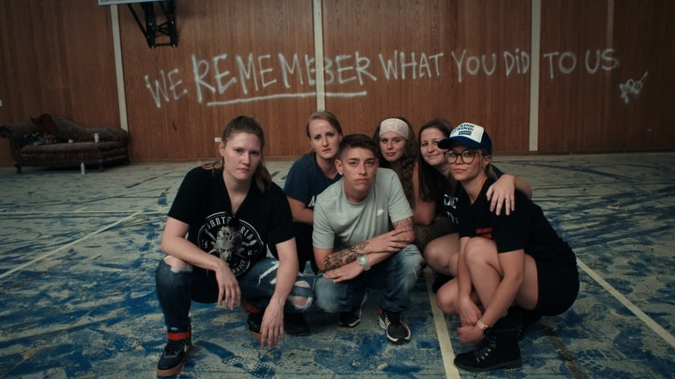 students crouched in a room