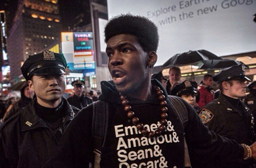 Myself standing as vanguard in a protest action in 2014. I’m standing in front of a line of NYPD officers.