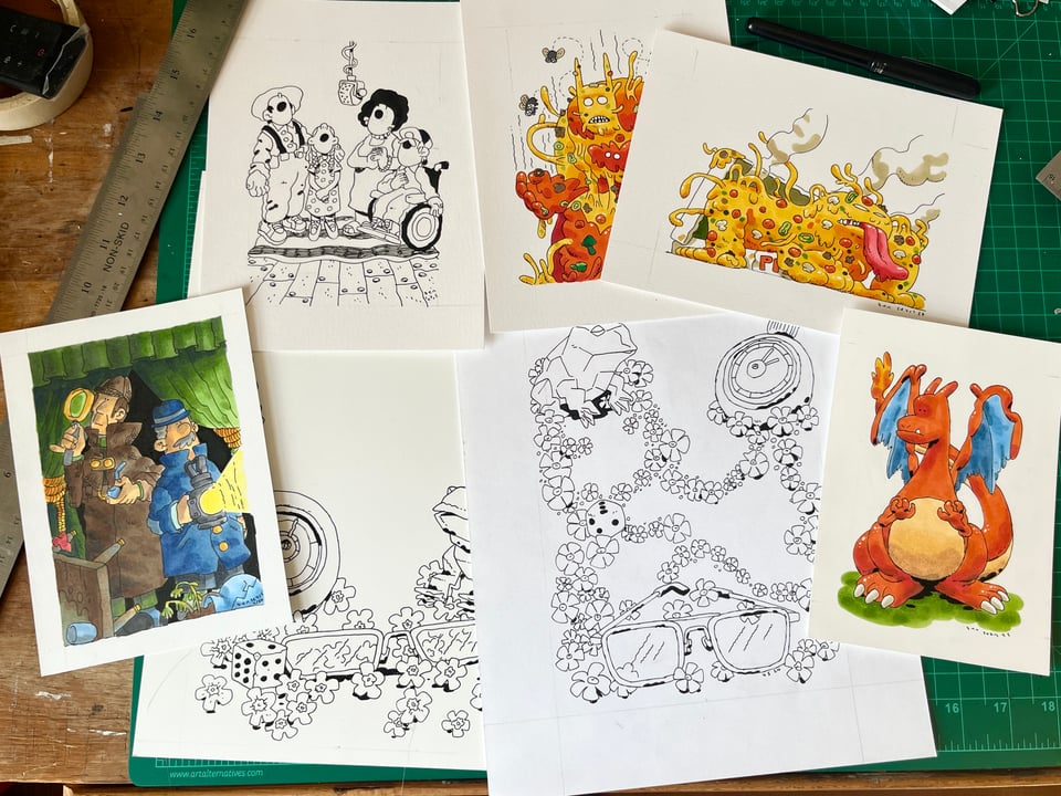 a picture of a stack of original drawings on a desk