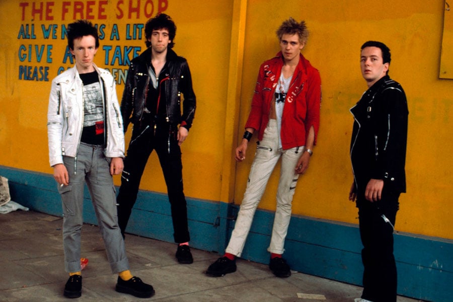 The Clash's best lineup, standing in front of a yellow wall.