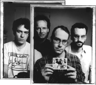 A PR photo of four men, made to look like two overlapping framed photos. The man second from right holds a photo of the photo they are in.