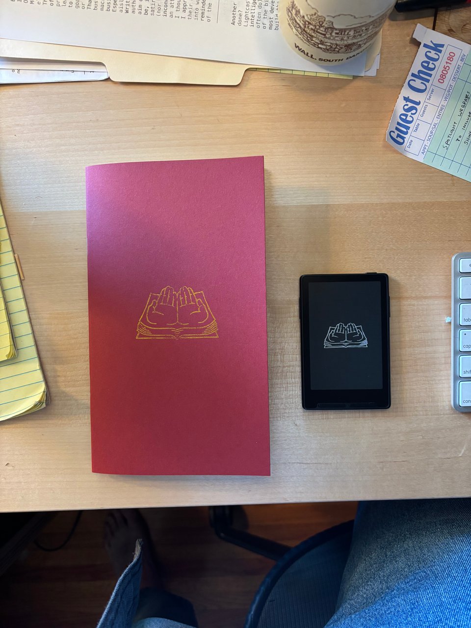 e-reader and pamphlet with same book motif