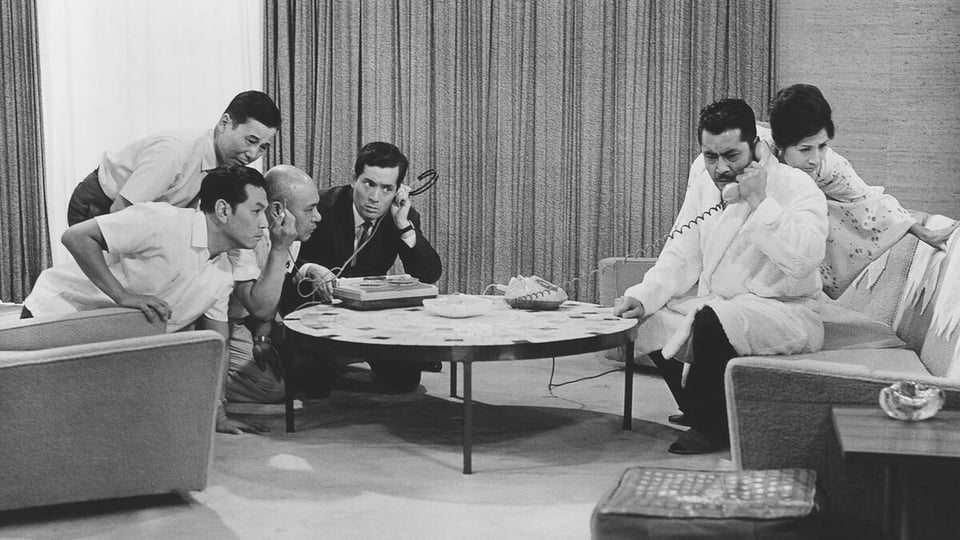 A scene from High and Low. The protagonists and the police listen to the kidnapper's call.