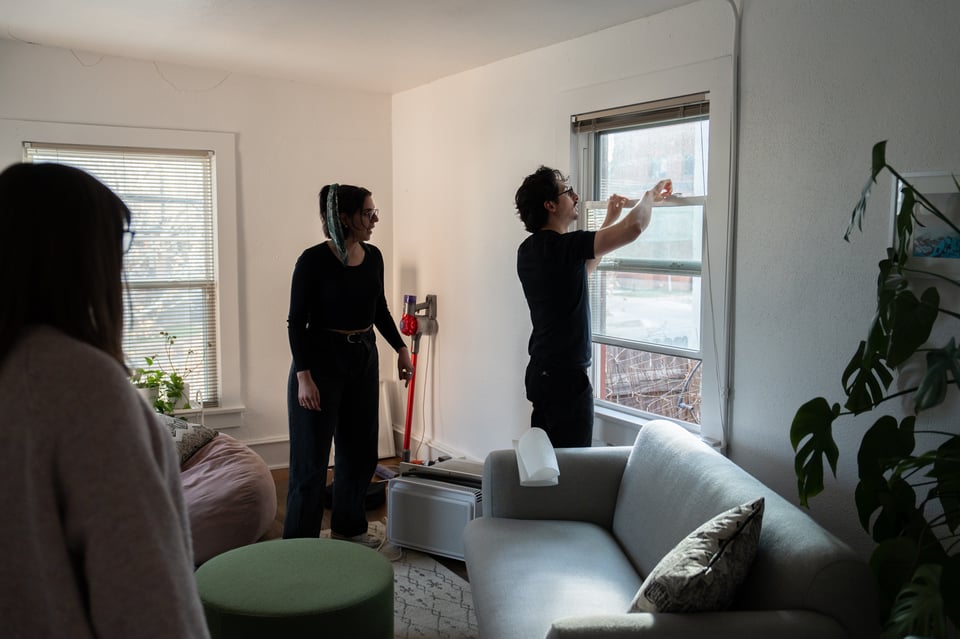An air conditioner being removed from a window.