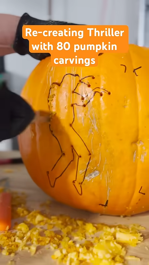 A video of someone carving a dancing figure into a pumpkin with the title "Re-creating Thriller with 80 pumpkin carvings"