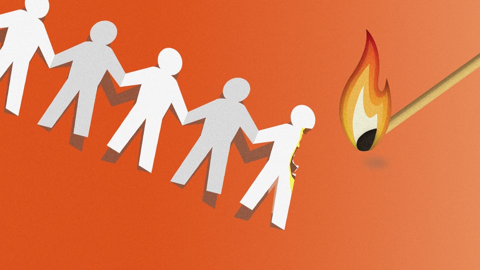 a group of paper cutout people with a match nearby