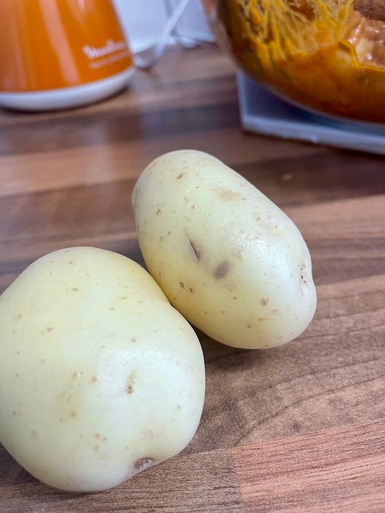 Potatoes with a potato salad in the background